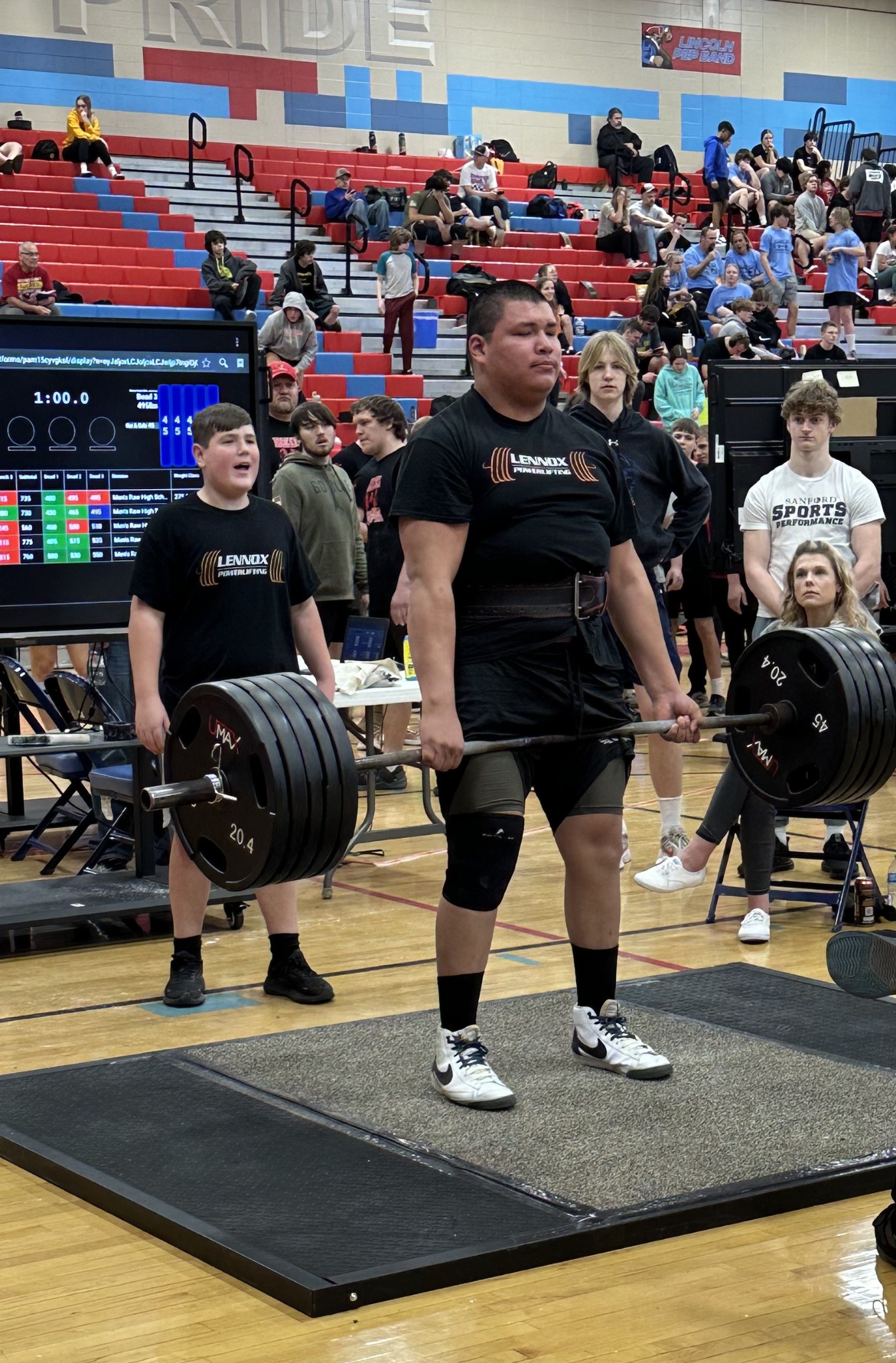 Powerlifter holding a deadlift on the competition platform